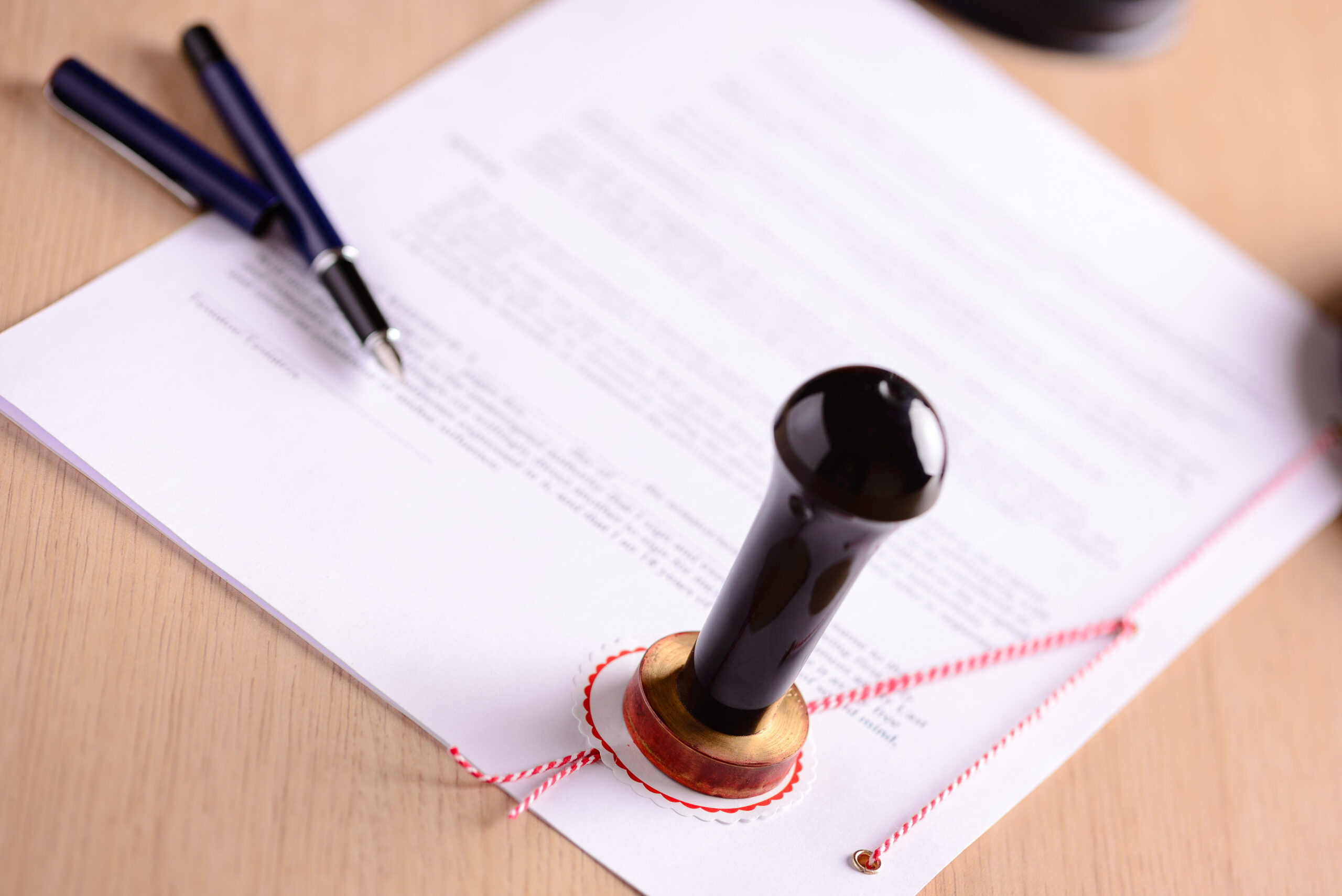 Notary's public pen and stamp on testament and last will.